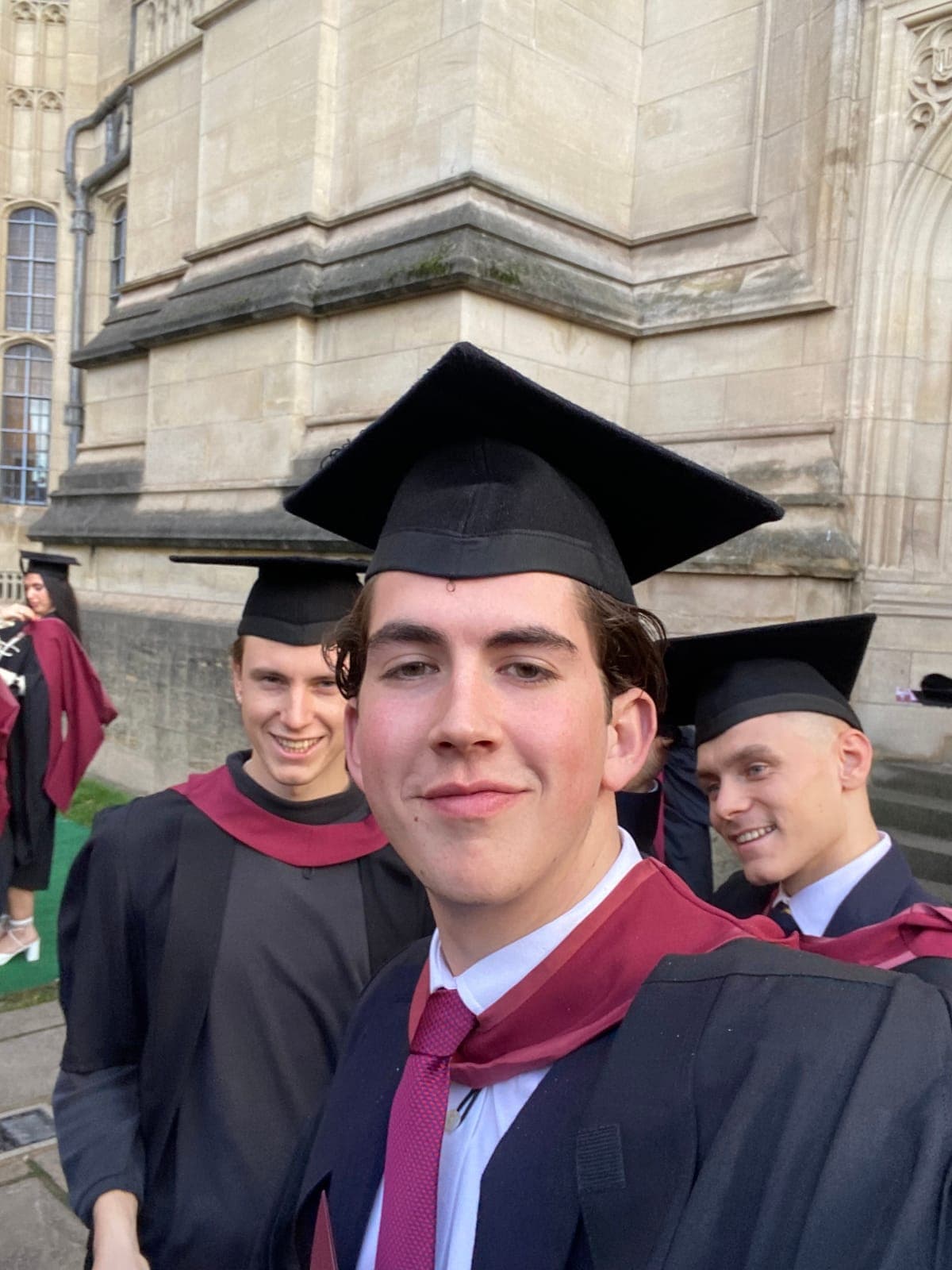 Graduation day selfie in cap and gown outside the Wills Memorial Building