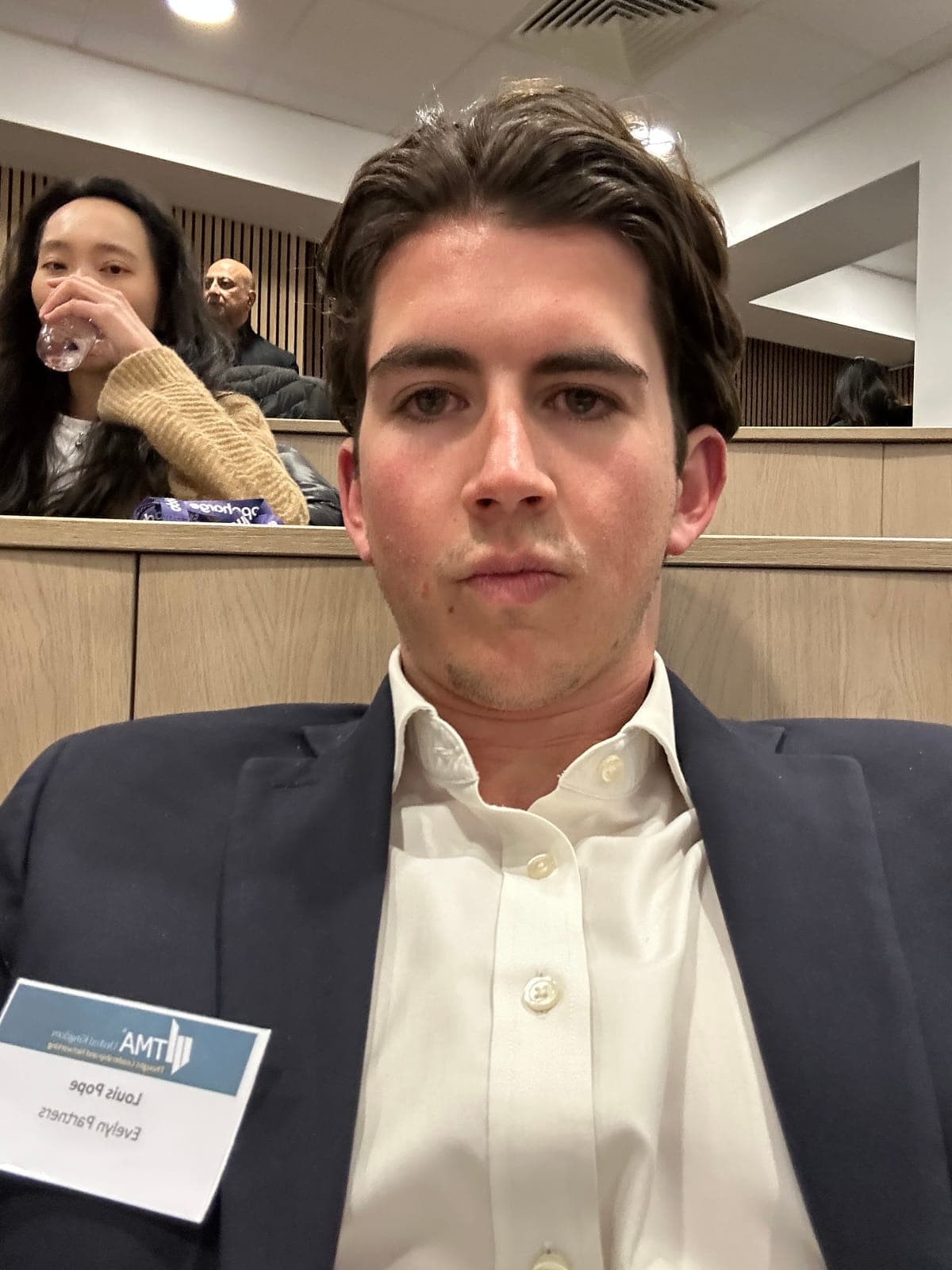 Louis at a TMA restructuring conference, Evelyn Partners name badge on