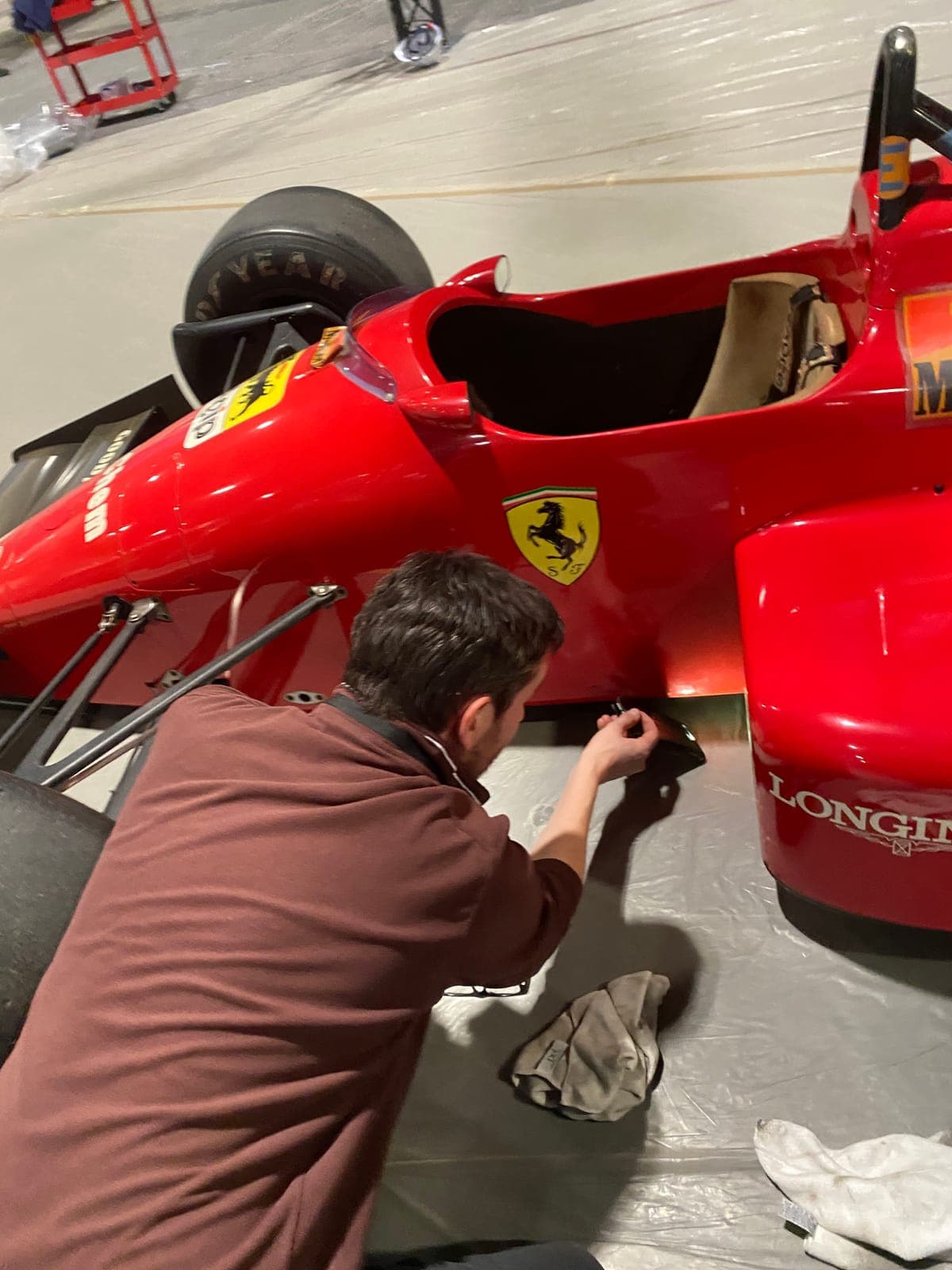 A Ferrari F1 car being prepped in the warehouse